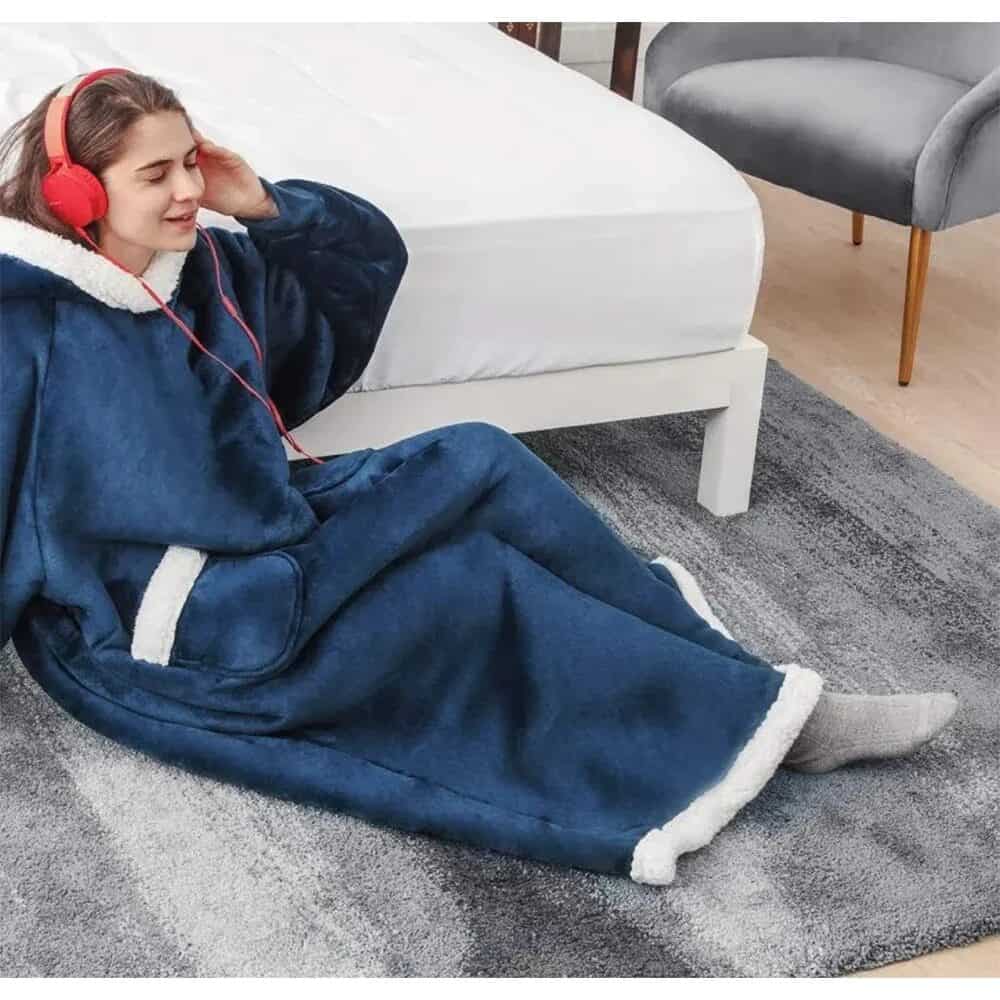 Person in blue blanket hoodie listening.
